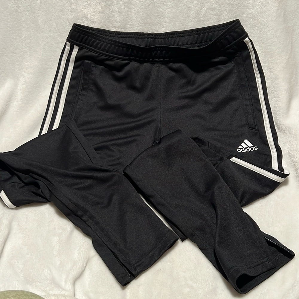 Halfway down the leg stripe, zippered bottom